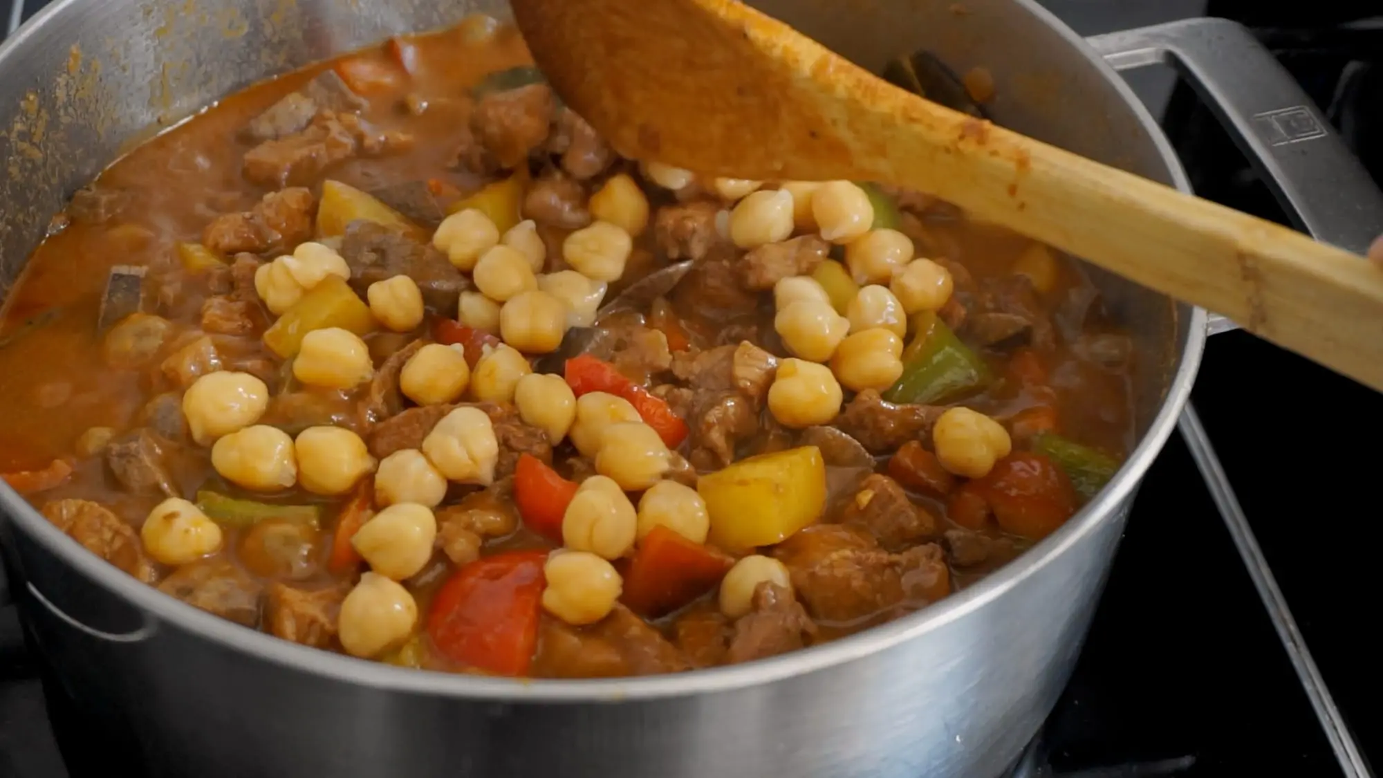 Garbanzos stirred into the simmering menudo