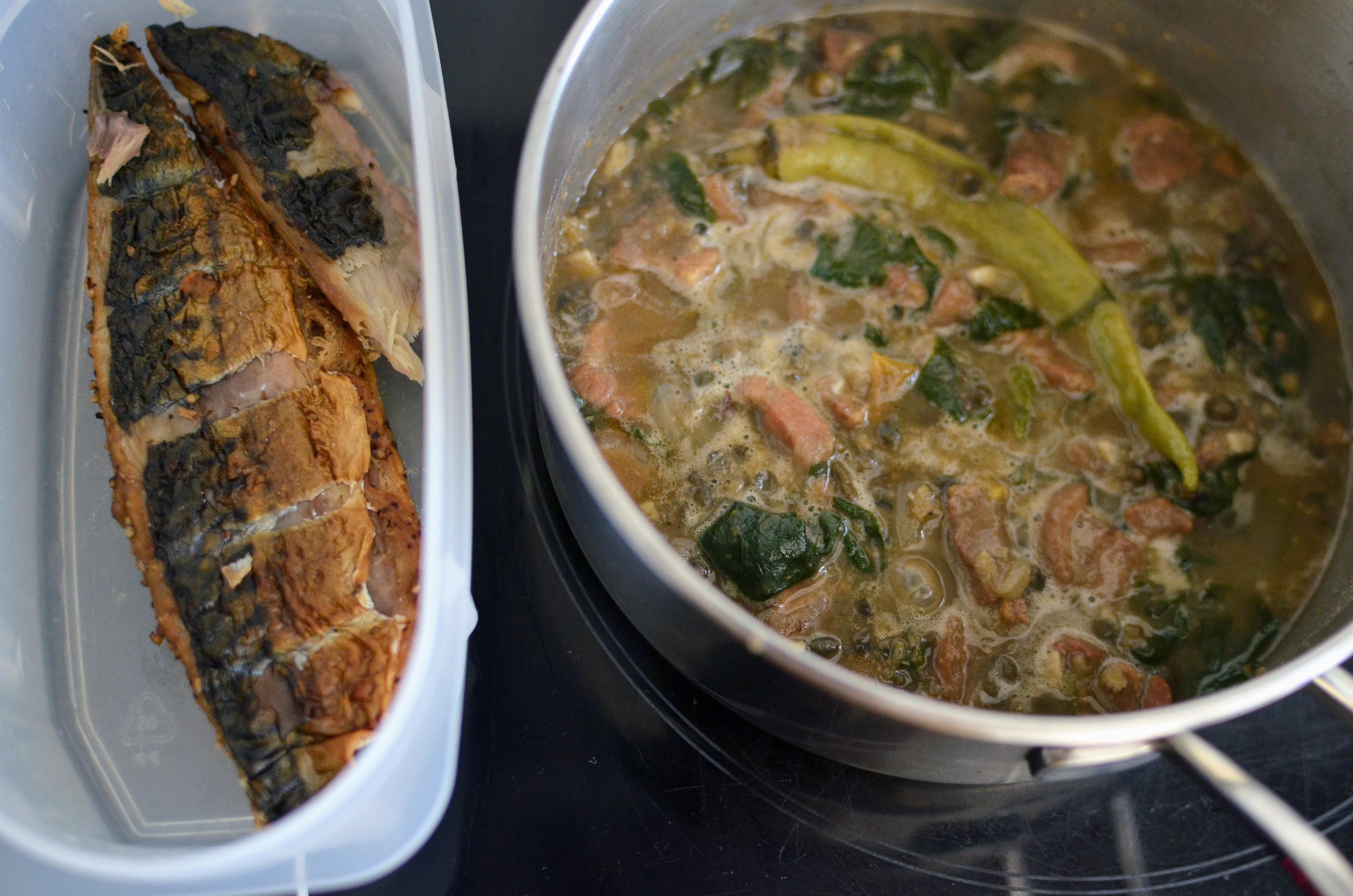 Ginisang monggo simmering in the pot alongside flaked tinapa