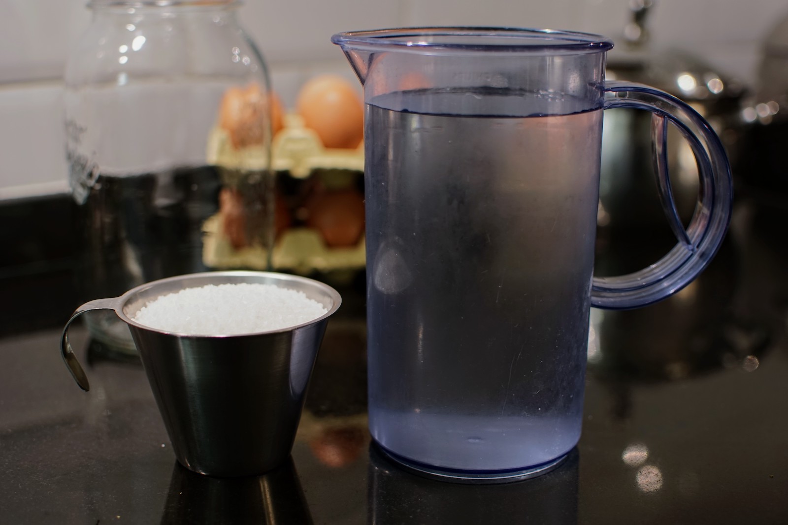 Cup of rock salt and a pitcher of water